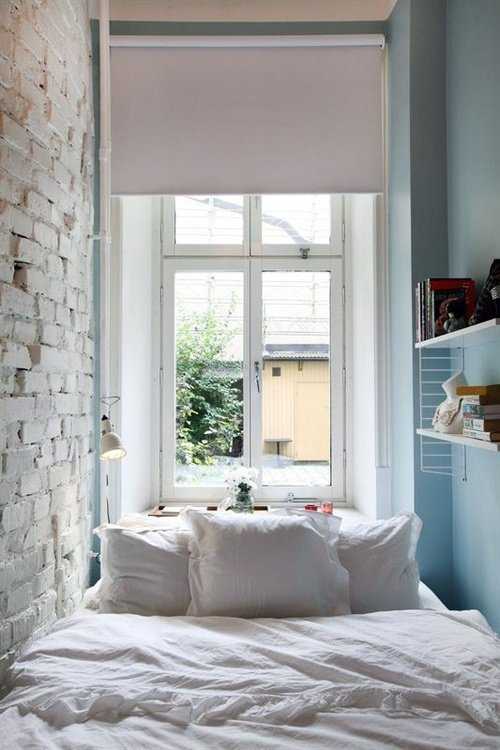 Кровать в спальне вдоль стены
